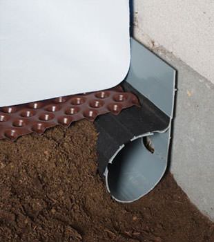 Closeup of a crawl space drainage system installed in Talbotton